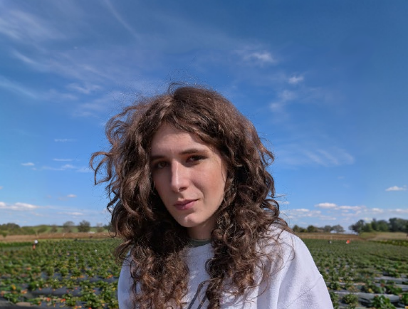 Merry (Me) standing in a strawberry field